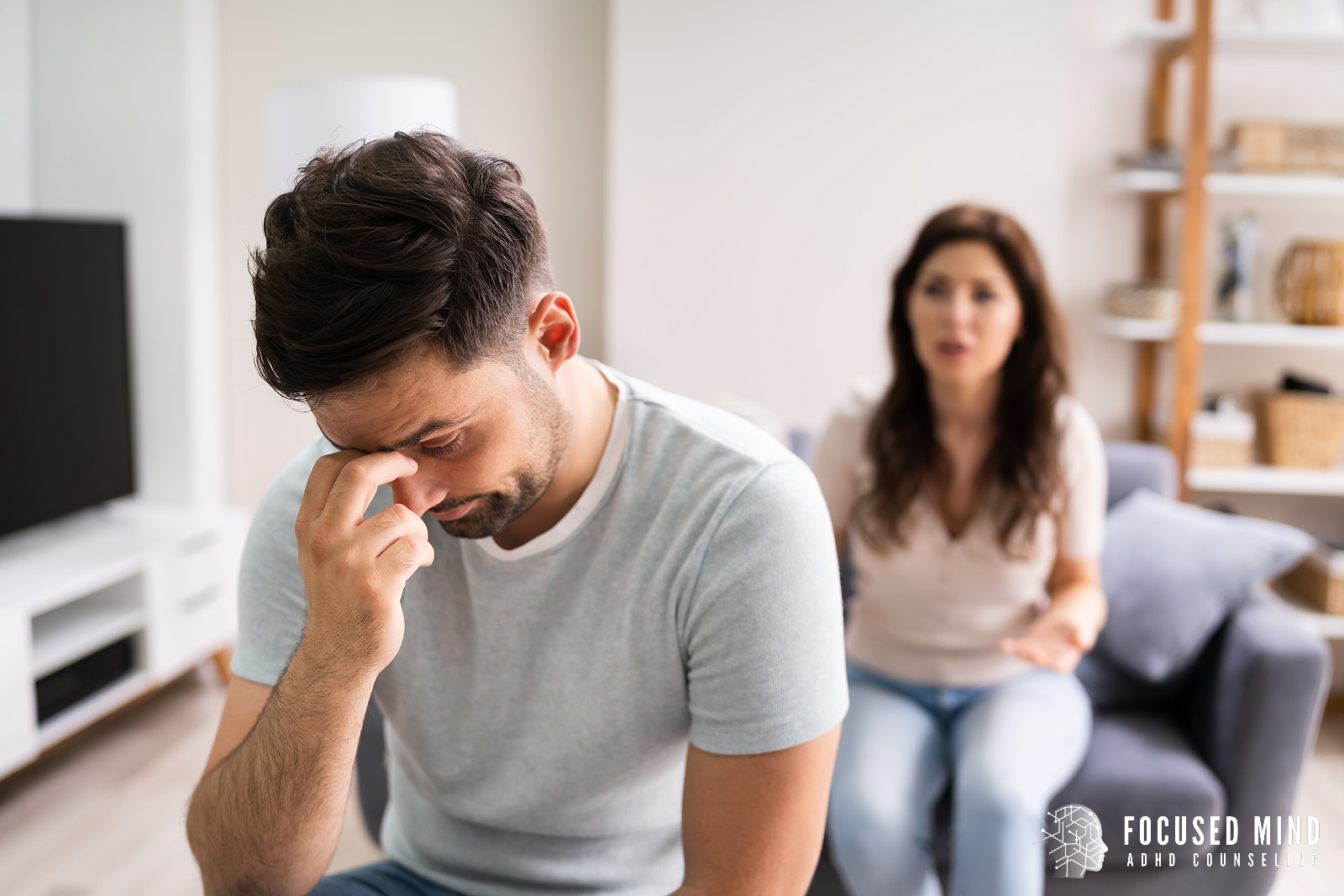 Upset man pinches the bridge of his nose as he turns away from his partner. He is struggling from emotional dysregulation, and it has started to effect his relationships. Focus Mind ADHD Counseling offers adult ADHD therapy in Columbus, OH, ADHD treatment for adults, and more. Contact us for support with adult ADHD therapy and ADHD emotional control.