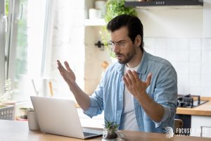 A man throws his hands up at his laptop in frustration. This could represent ADHD symptoms interfering with work. Contact Focused Mind ADHD counseling for ADHD testing in Columbus, OH to better understand your symptoms. Contact us to use our adult ADHD quiz and other services. 