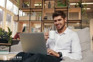 A person smiles with a cup in hand has they type on their laptop. This could represent the support online therapy in Columbus, OH offers. Contact a therapist in Columbus Ohio to learn more about ADHD and emotional regulation today. Focused Mind ADHD Counseling can help you unlock your ADHD superpowers! 43085 | 43220 | 43235 