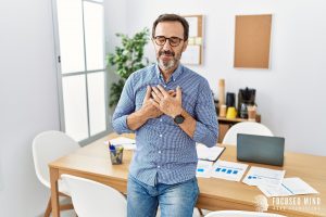 A man holds his hands over his heart with a relived expression. ADHD and emotional regulation often go hand and hand, and emotional regulation therapy in Columbus, OH can offer support. Learn more by searching "adhd specialist" near me today for more. 