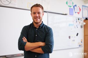 A teacher smiles with arms crossed while standing in a classroom. Learn how ADHD and relationships can be affected by RSD and contact an adult ADHD specialist in Ohio for support. Search for ADHD treatment for adults in Ohio for more info today.
