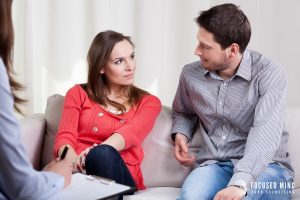 A couple engages in couples therapy with a professional, working on communication in relationships and emotional connection during ADHD shutdown moments.