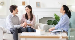 A couple holding hands during a session with a therapist in Columbus Ohio, focusing on ADHD and emotional regulation through emotional regulation therapy in Columbus, OH and care from an adult ADHD therapist in Ohio for emotional dysregulation ADHD Columbus, OH.