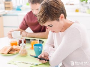 A distant couple during breakfast shows signs of ADHD and emotional regulation challenges, emphasizing the need for emotional dysregulation ADHD Columbus, OH support from a therapist in Columbus Ohio and guidance from an ADHD therapist for adults near me.