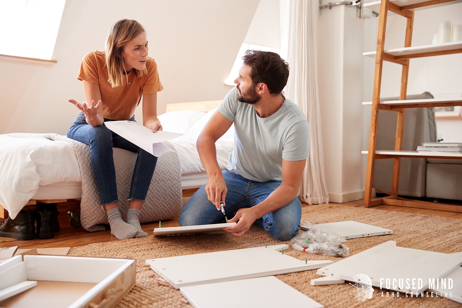A couple sits in their bedroom assembling furniture while arguing, reflecting challenges discussed in couples therapy in Columbus, OH with an ADHD couples therapist in Columbus, OH and how ADHD in adults Ohio can impact communication.