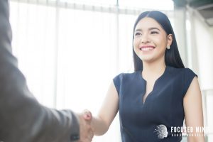 A young professional smiles while shaking hands, showing confidence and connection. Many achieve this growth with ADHD treatment for adults in Columbus, Ohio, guided by an adult ADHD therapist in Columbus, OH and the supportive care of an ADHD therapist for adults near me.