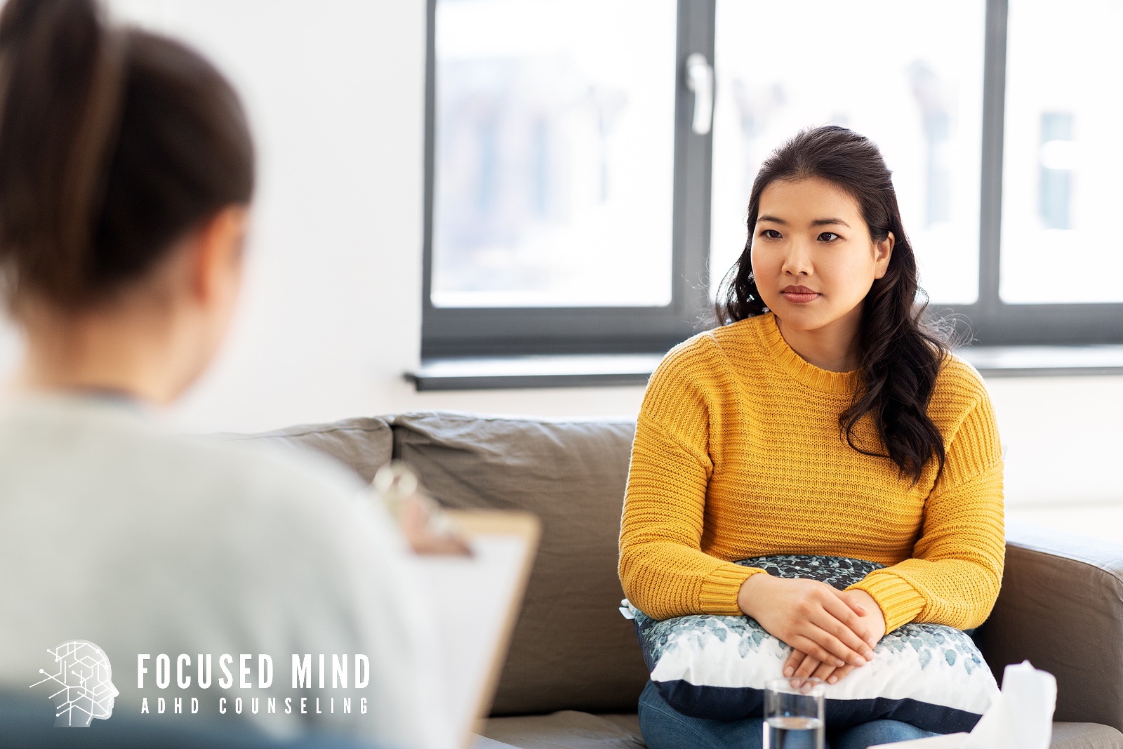 A woman in a therapy office listens attentively while taking notes during a session. Are you wondering whether an ADHD diagnosis could help explain long-standing concentration struggles? Online ADHD testing in Cleveland, OH, can provide insight and direction.
