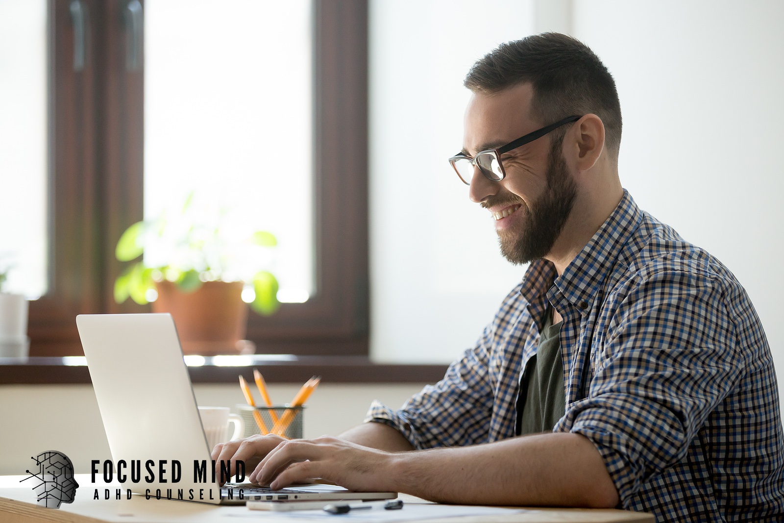 A smiling man typing on a laptop. Are you ready to explore what an ADHD assessment is all about? Online ADHD testing in Cincinnati, OH, offers a structured evaluation and convenient, ongoing virtual support.