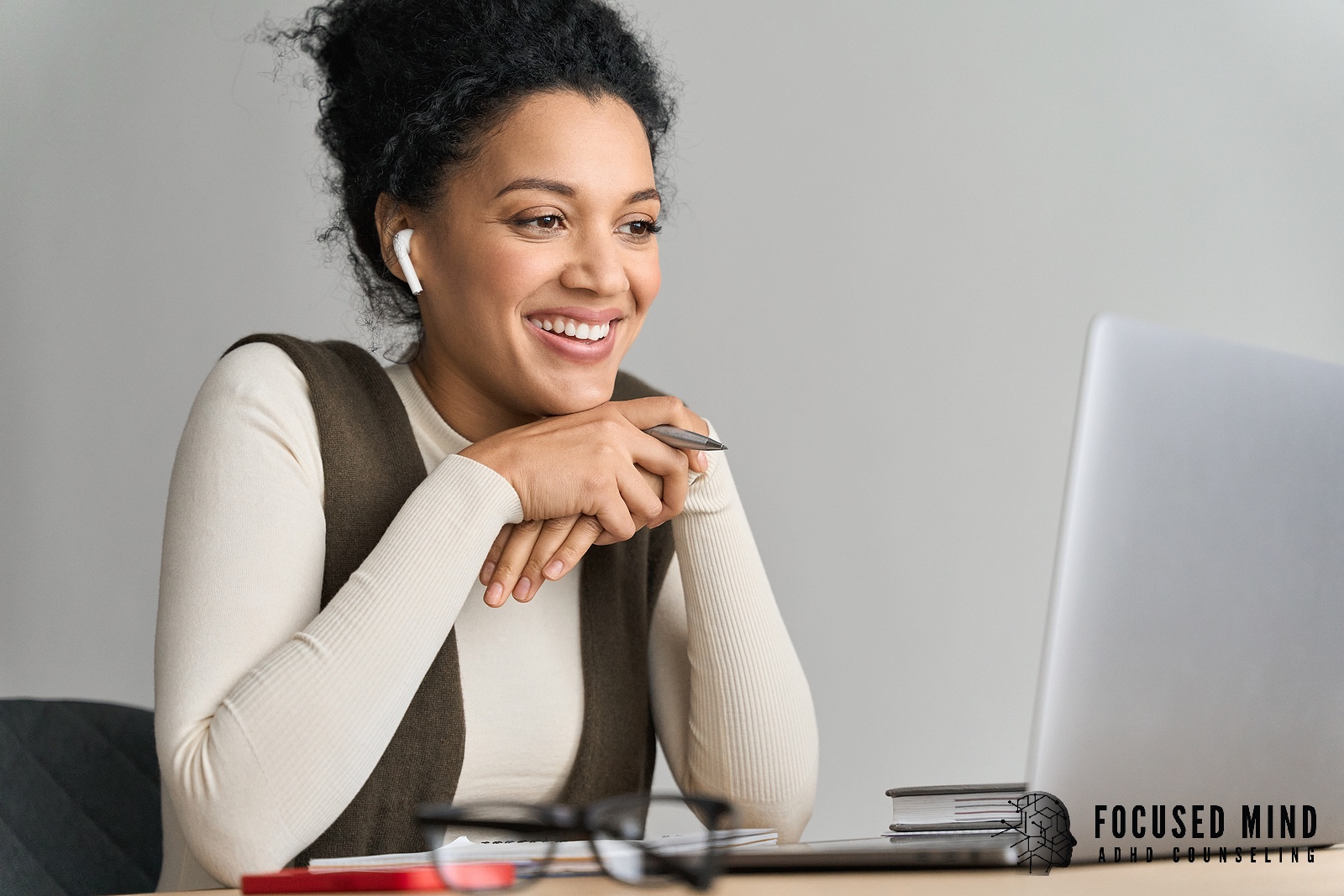 A woman smiles at a laptop screen during a video call. Are you unsure whether you should get diagnosed with ADHD online? Discover how an online ADHD therapist in Cincinnati, OH, can help you take the first step forward. 