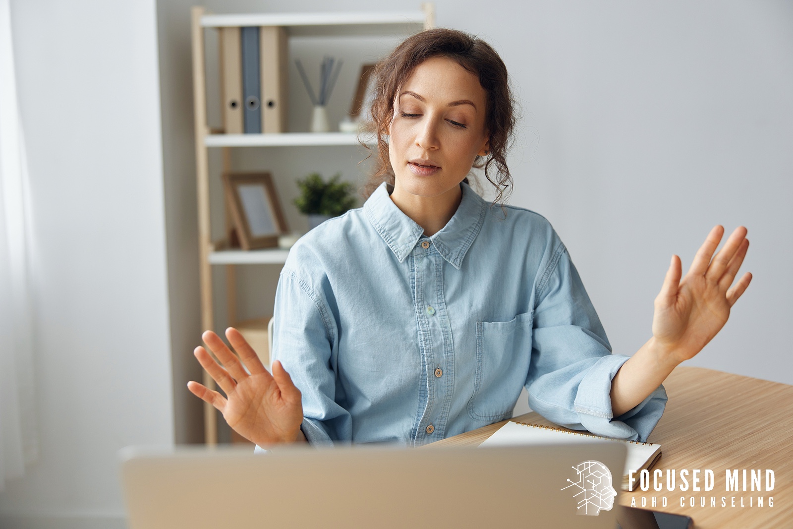 A woman raises her hands while talking on a video call. Does your body feel constantly tense or restless from ADHD symptoms? An online ADHD specialist in Cincinnati, OH, addresses the physical manifestations of ADHD beyond cognitive challenges.