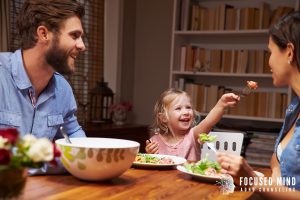 Family sharing dinner together, symbolizing the goal of getting home on time and feeling present. Adult adhd treatment in columbus, oh, online adhd treatment in columbus, oh, and support from an adhd therapist in columbus, oh can make routines easier.