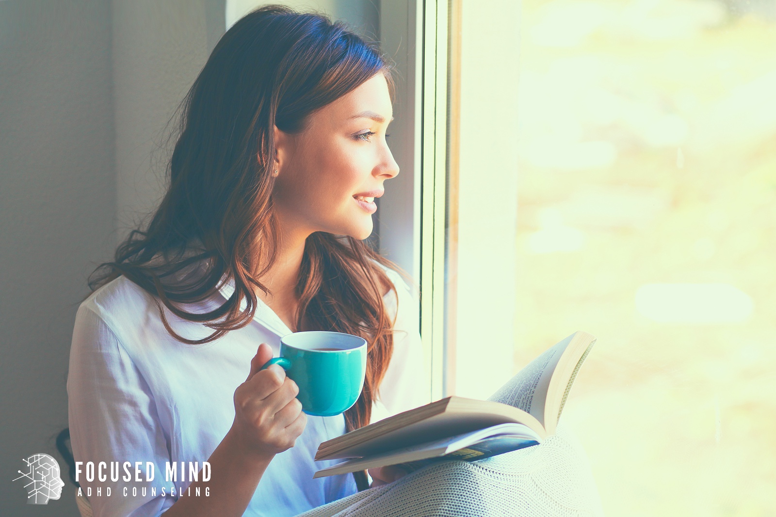 Woman reading by a sunny window, reflecting on anxiety symptoms columbus, oh and adhd and anxiety in adults columbus, oh. Support like anxiety therapy in columbus, oh can help quiet racing thoughts.