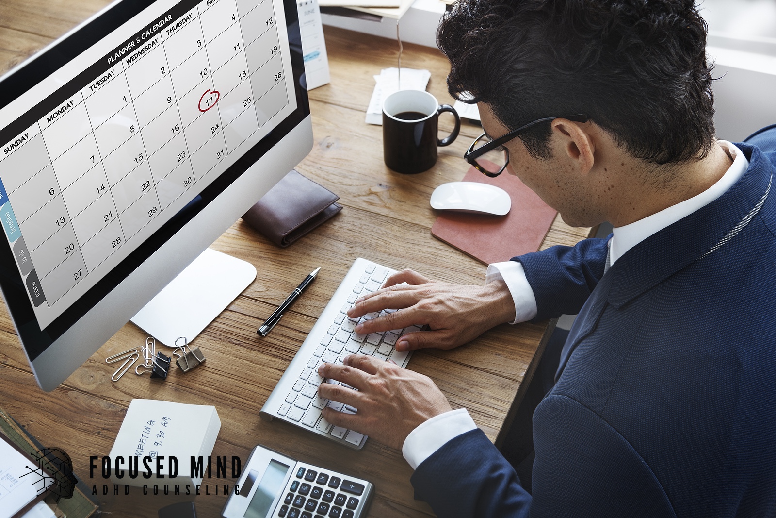 A man in a suit reviews a calendar on his computer screen. Time blindness can make managing deadlines and appointments a constant source of stress with ADHD. ADHD testing in Cleveland, OH can help identify what's making time management so difficult.