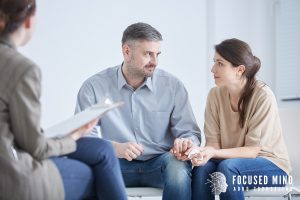 A couple sits across from a therapist in a calm counseling office, engaged in a focused conversation about their relationship patterns and communication challenges. This image captures the assessment and planning phase that is central to ADHD focused couples therapy in Columbus, OH — the work of identifying exactly where communication breaks down and building systems that support both partners. An experienced ADHD couples therapist in Columbus, OH helps couples move from frustration and repetition toward clarity and real connection.