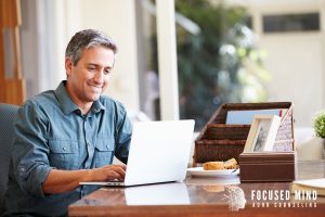Adult using a laptop at home, exploring online adhd treatment in columbus, oh for better time management and follow-through. A columbus adhd therapist and adult adhd specialist in ohio can help address adhd and anxiety in adults columbus, oh.