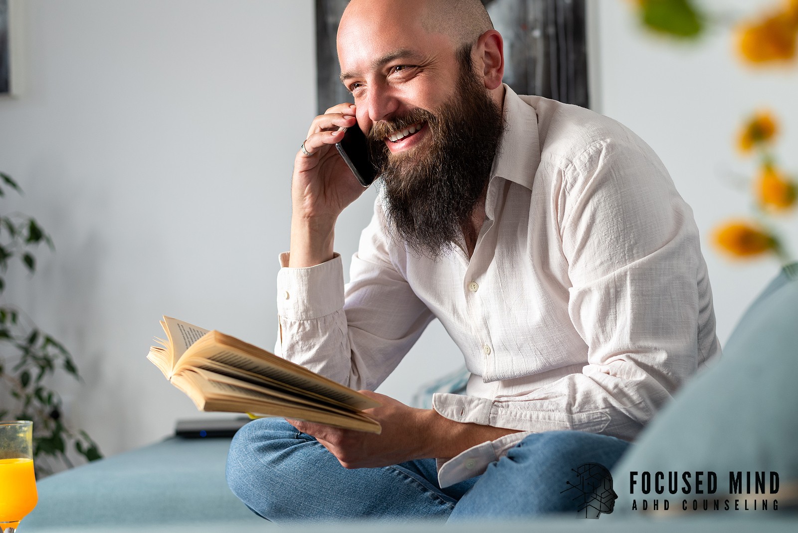 A man talks on the phone while holding an open book on a couch. Could understanding the difference between ADD and ADHD change how you approach your daily life? ADHD testing in Cincinnati, OH, can provide the answers you've been looking for.
