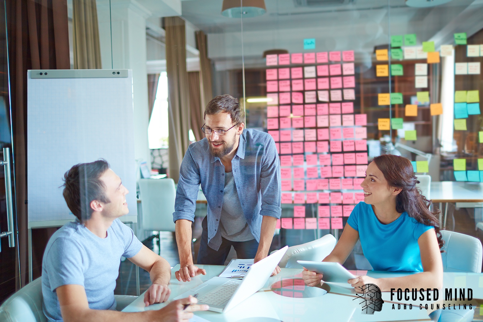 Three colleagues collaborate around a conference table. How can understanding your ADHD transform the way you communicate, lead, and succeed in your career? An ADHD specialist in Cincinnati, OH, can help you unlock your full professional potential.