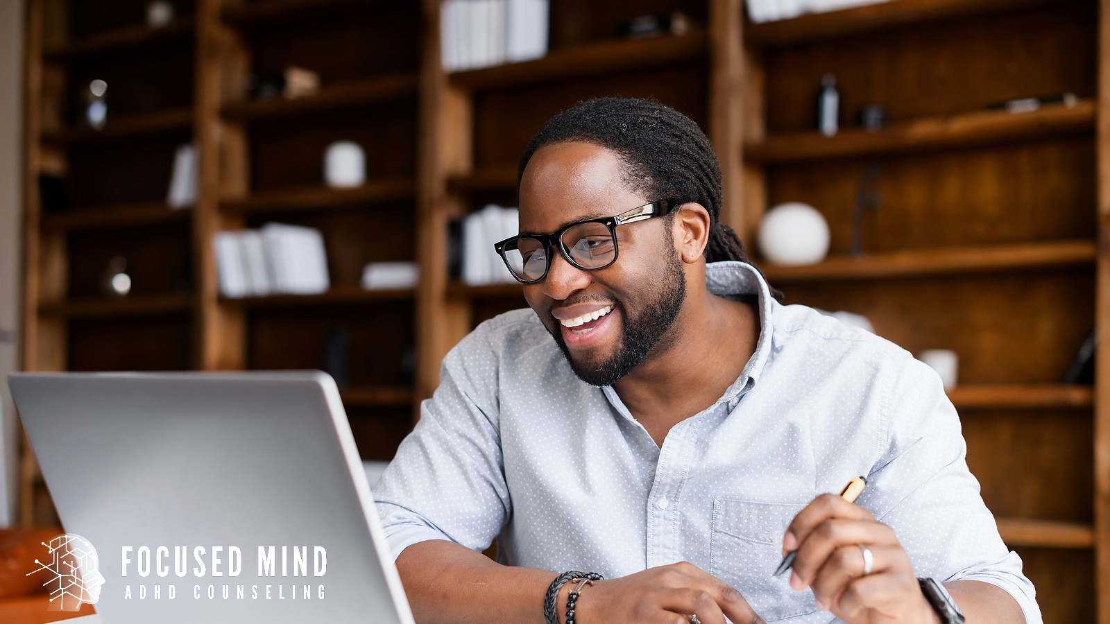 A man with glasses smiles while looking at a laptop. Is an accurate diagnosis the missing piece that could change how you understand yourself and your challenges? An ADHD specialist in Cleveland, OH can provide a comprehensive evaluation to get you real answers.