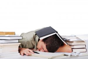 A teenage boy has given up on studying entirely, slumped face-down on a desk surrounded by stacks of books with an open notebook balanced on his head — capturing the exhaustion and shutdown that often accompanies undiagnosed ADHD. For parents wondering whether their teen's inconsistent performance and avoidance of schoolwork might point to something deeper, an ADHD assessment for teenagers in Columbus, OH can provide the clarity and direction the whole family needs. An ADD test for teens in Columbus, OH helps distinguish between lack of effort and a brain that genuinely struggles with focus and follow-through.